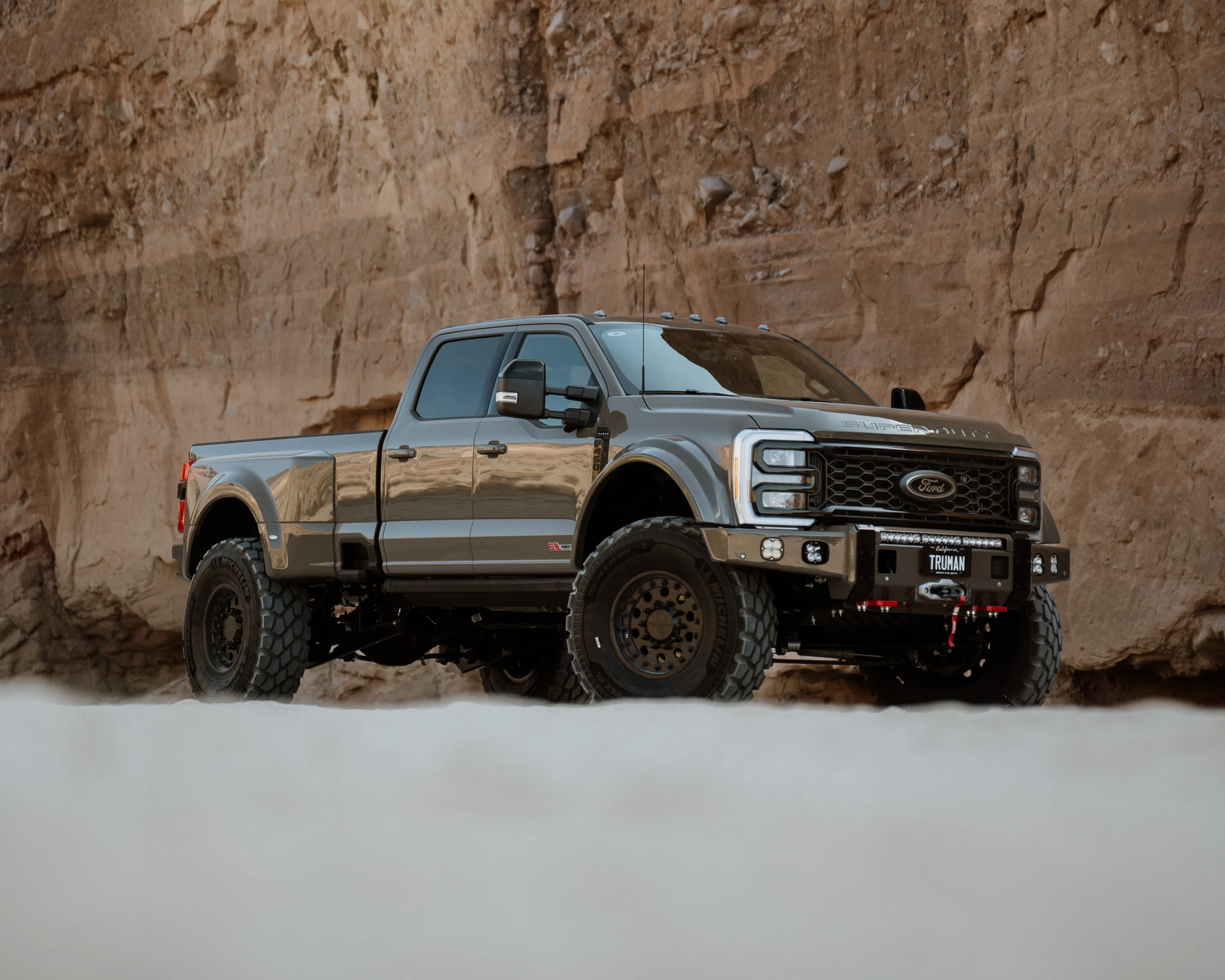 Truman builds in desert terrain.