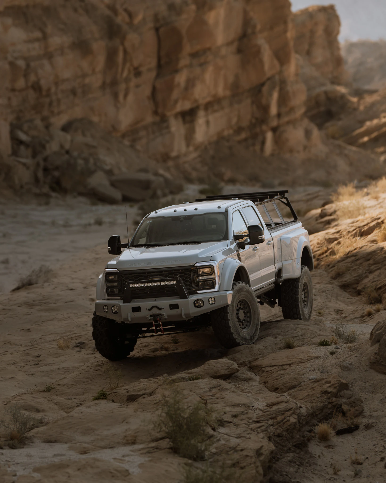 Silver Truman Super Duty exploring a desert canyon